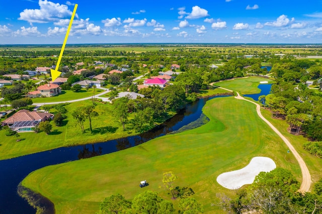 aerial view with a residential view, view of golf course, and a water view