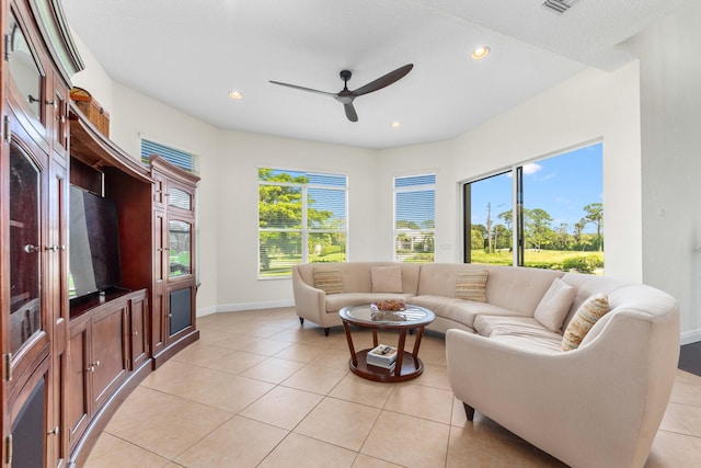 living area with light tile patterned floors, baseboards, a ceiling fan, and recessed lighting