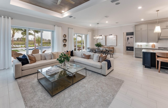 living room with crown molding, a raised ceiling, and ceiling fan