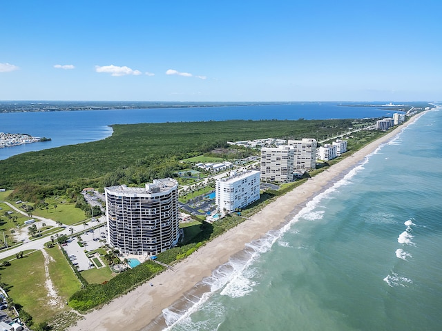 aerial view with a water view and a view of the beach