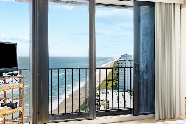 balcony featuring a water view and a beach view