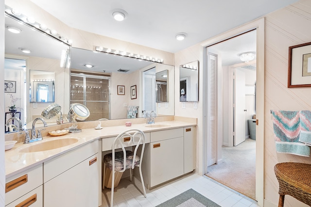 bathroom with walk in shower, vanity, and tile patterned flooring