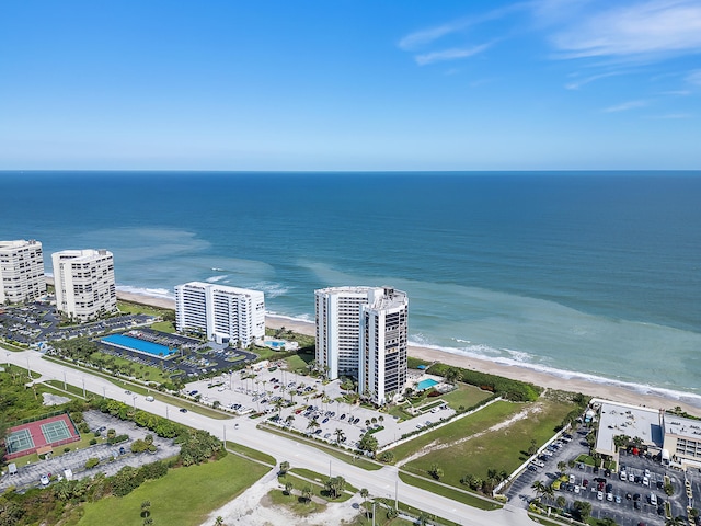 birds eye view of property with a water view and a view of the beach