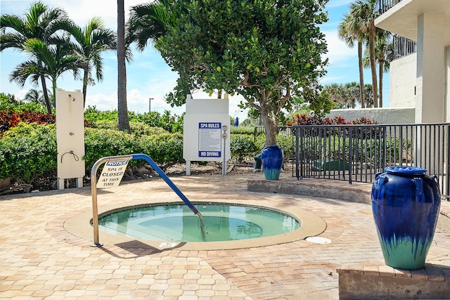 view of swimming pool with a community hot tub