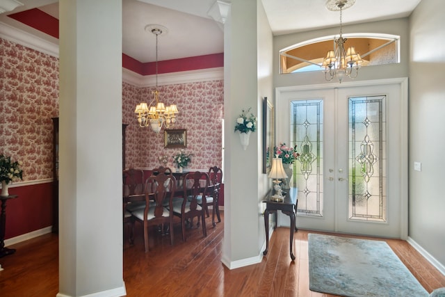 entryway featuring french doors, a notable chandelier, lofted ceiling, and hardwood / wood-style flooring