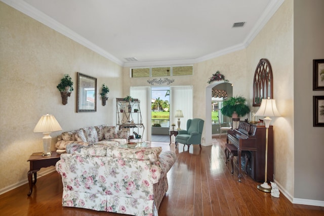 living room with hardwood / wood-style flooring and crown molding