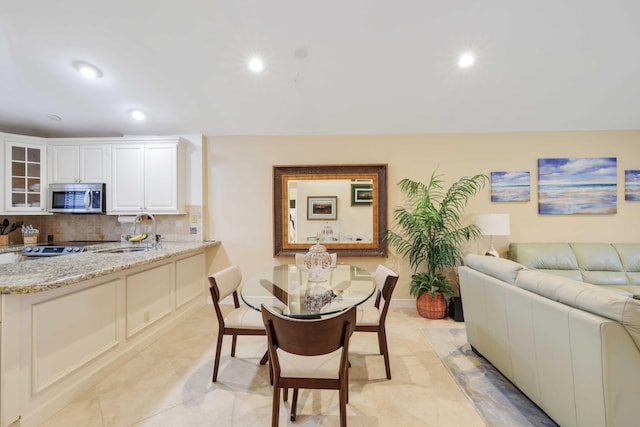 dining room with light tile patterned floors and sink