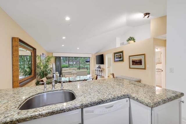 kitchen with dishwasher, white cabinets, sink, vaulted ceiling, and light stone countertops