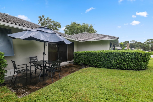 back of house with a lawn