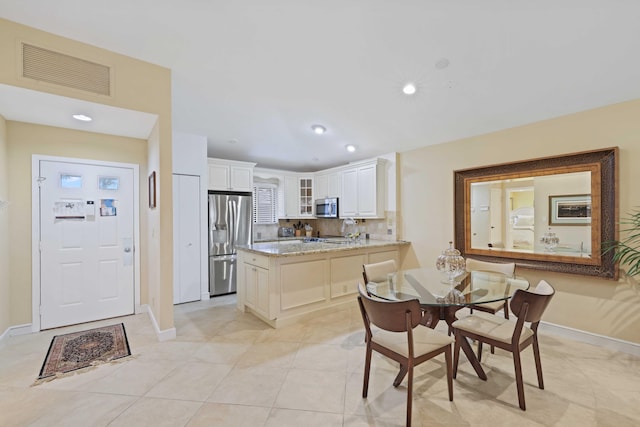 dining space featuring light tile patterned floors