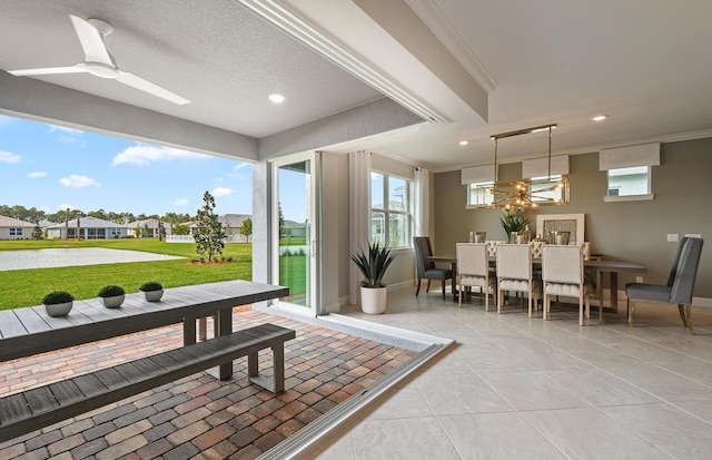 interior space with a water view and ceiling fan