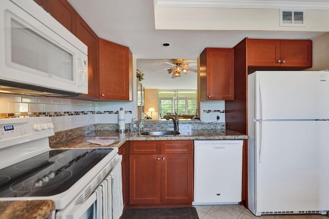 kitchen featuring ceiling fan, light tile patterned flooring, sink, white appliances, and stone counters