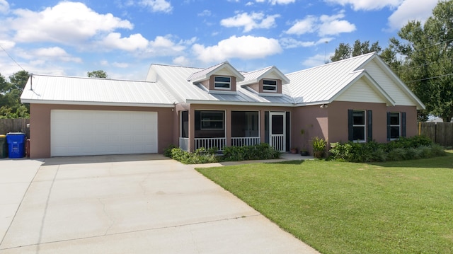 view of front of home featuring a porch, a garage, and a front yard