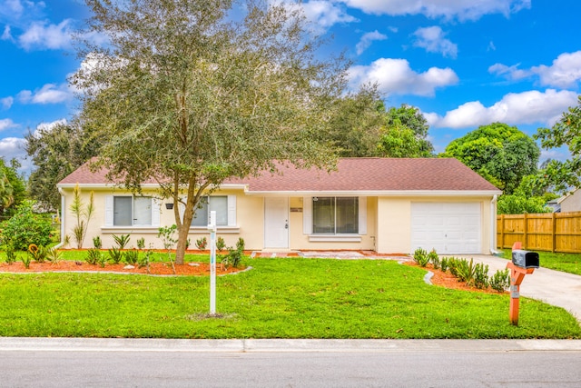 view of front of property with a front lawn and a garage