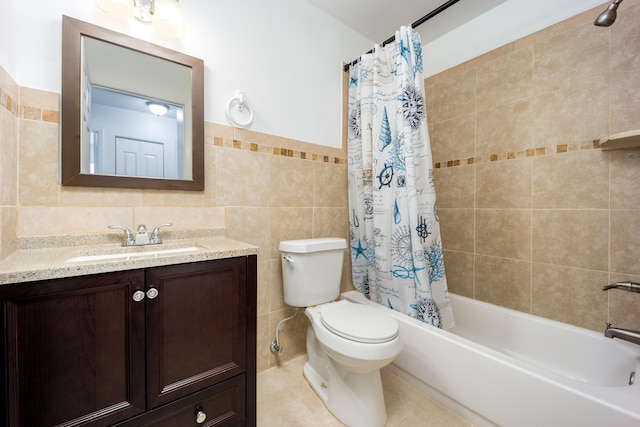 full bathroom featuring shower / bath combination with curtain, toilet, tile walls, vanity, and tile patterned flooring