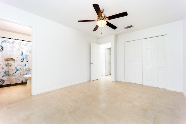 unfurnished bedroom featuring connected bathroom, a closet, and ceiling fan