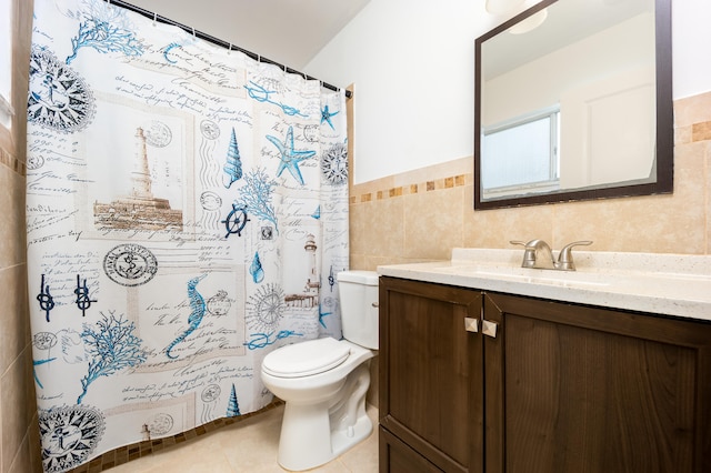 bathroom featuring toilet, tile patterned flooring, curtained shower, tile walls, and vanity