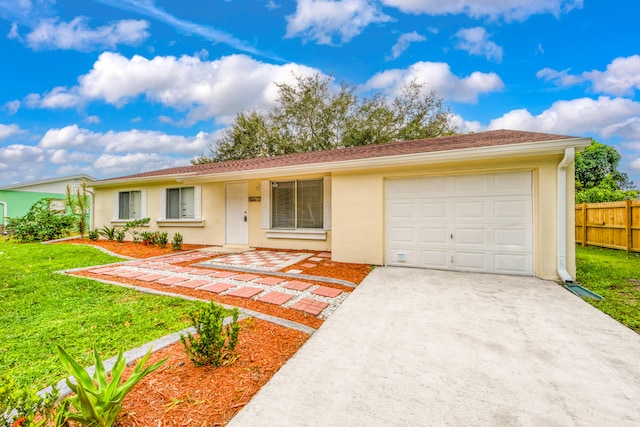 single story home with a front yard and a garage