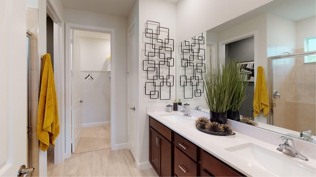 bathroom with vanity and a shower with shower door