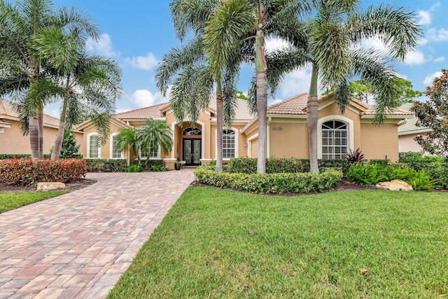 mediterranean / spanish home featuring a front lawn