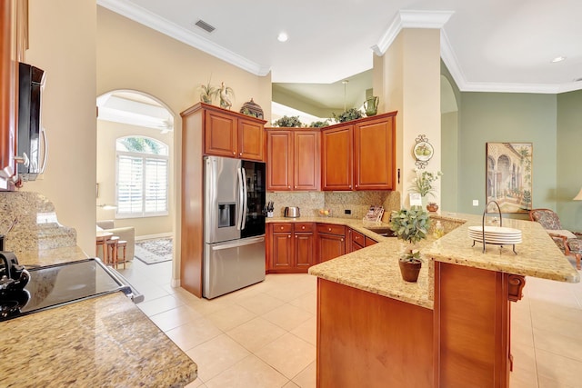 kitchen featuring kitchen peninsula, ornamental molding, stainless steel fridge with ice dispenser, and a kitchen bar