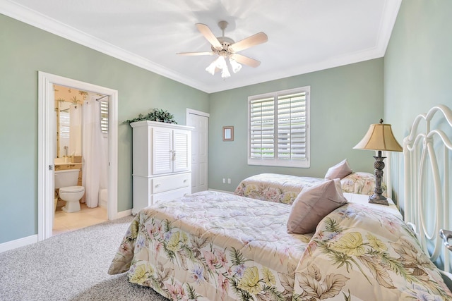 bedroom with ceiling fan, light colored carpet, crown molding, and ensuite bathroom