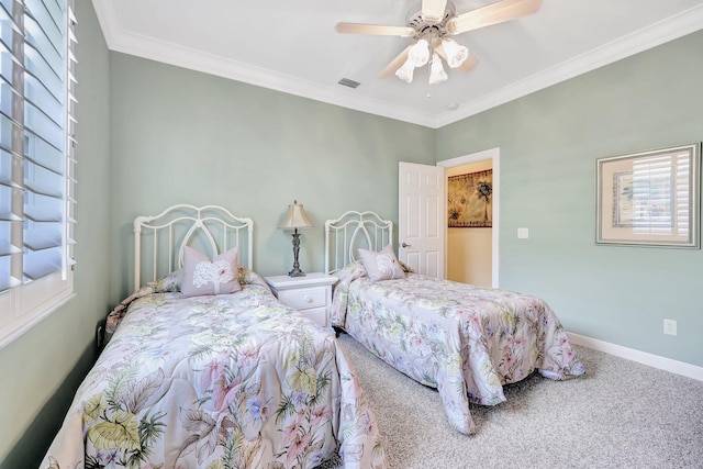 carpeted bedroom with ornamental molding and ceiling fan