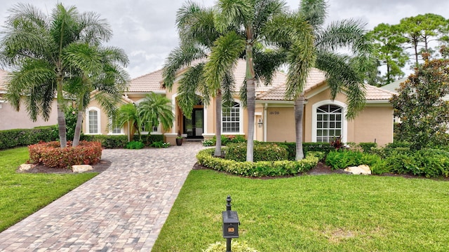 mediterranean / spanish house featuring a front yard