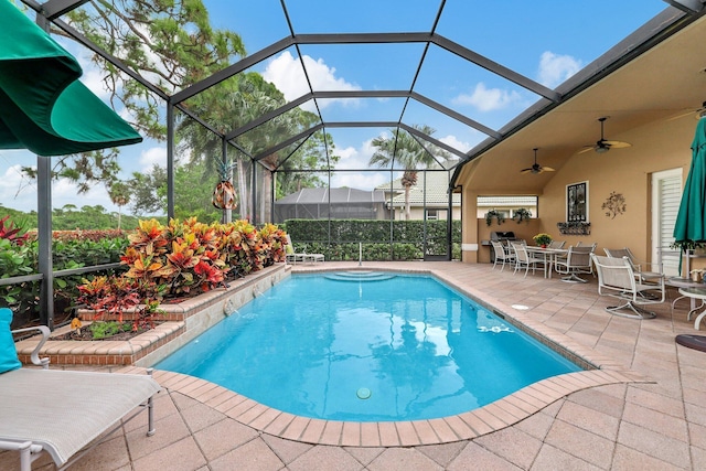 view of swimming pool with a lanai, a patio, and ceiling fan