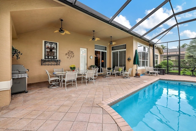 view of swimming pool with a patio, a lanai, ceiling fan, and a grill