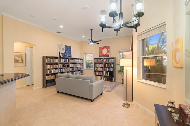 tiled living room with crown molding, a chandelier, and plenty of natural light