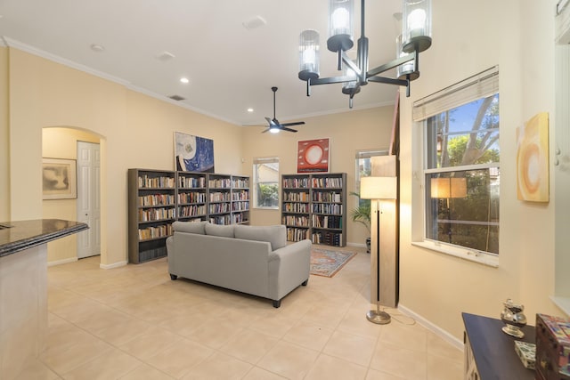 sitting room with plenty of natural light, light tile patterned floors, and ornamental molding