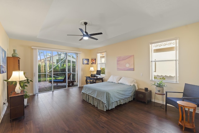 bedroom with ceiling fan, dark wood-type flooring, and access to exterior