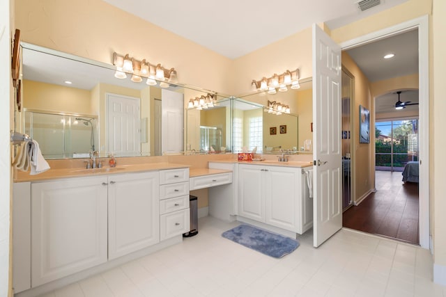 bathroom with a shower with door, vanity, hardwood / wood-style floors, and ceiling fan