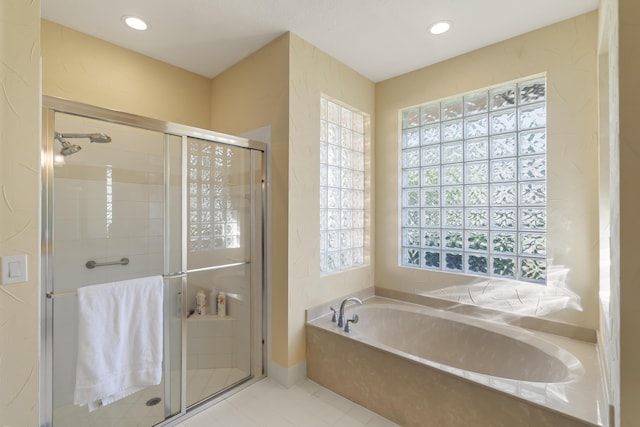 bathroom with tile patterned floors and independent shower and bath