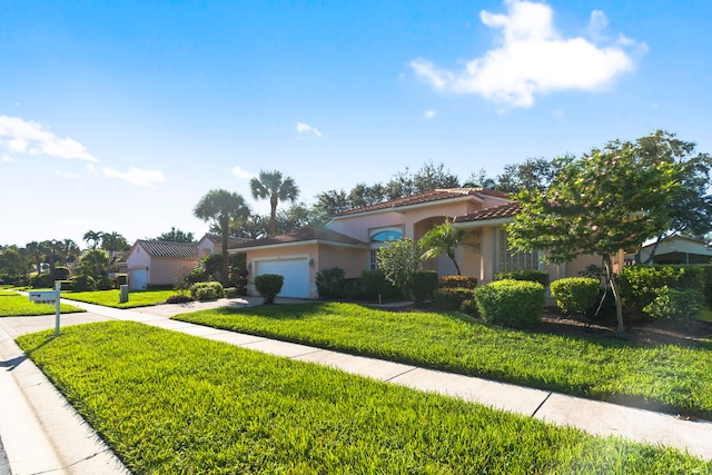 view of front of house featuring a front yard and a garage