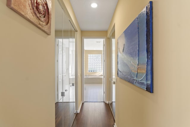 corridor with dark hardwood / wood-style flooring