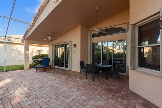 view of patio / terrace featuring ceiling fan and a lanai