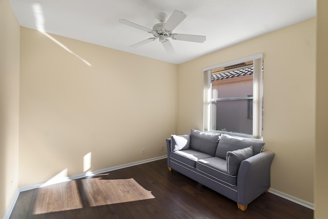 sitting room with ceiling fan and dark hardwood / wood-style flooring