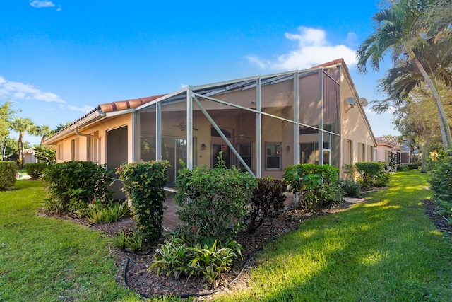 view of property exterior featuring a yard and glass enclosure