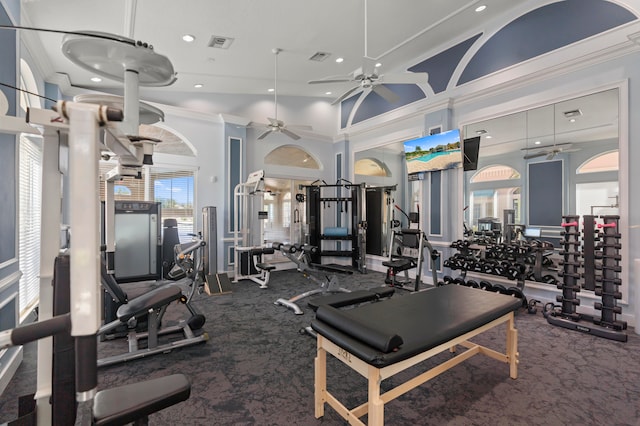 gym featuring ornamental molding, a high ceiling, and carpet floors