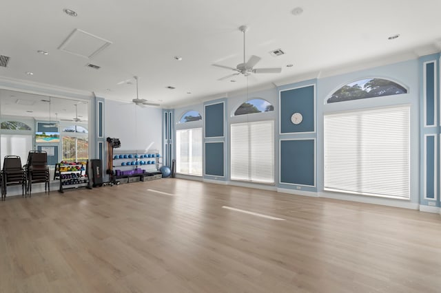 exercise room with light hardwood / wood-style floors, crown molding, a healthy amount of sunlight, and ceiling fan