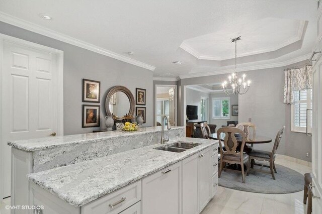 10103 Wild Quail Dr, Port Saint Lucie, FL 34986 - kitchen with a center island with sink, a sink, white cabinets, open floor plan, and a wealth of natural light