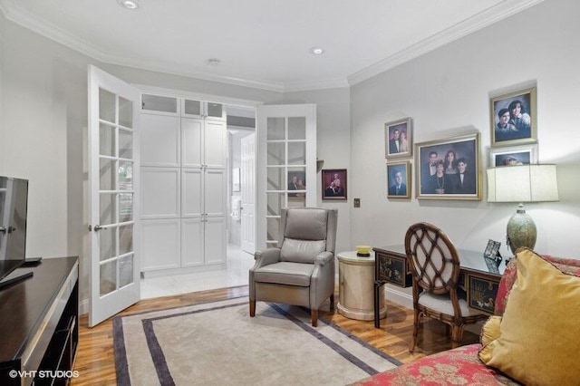 living area with ornamental molding, light hardwood / wood-style flooring, and french doors