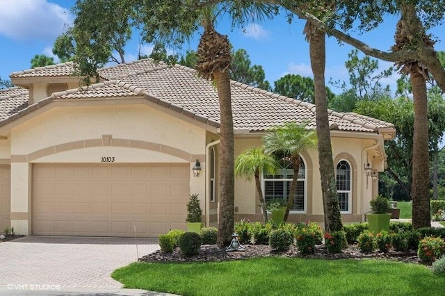 mediterranean / spanish home with a garage