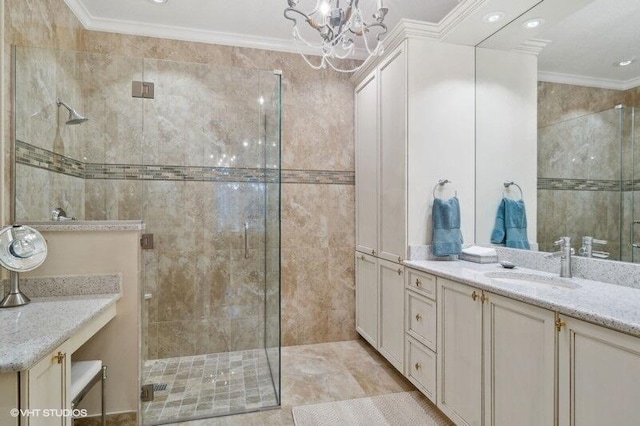 bathroom featuring ornamental molding, vanity, tile walls, and a shower with shower door