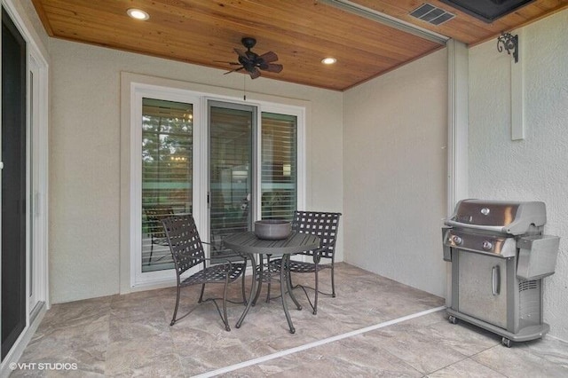 view of patio with ceiling fan and area for grilling