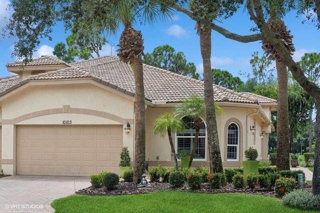 mediterranean / spanish house with a garage