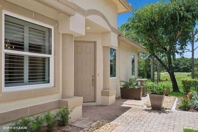 view of exterior entry featuring a patio