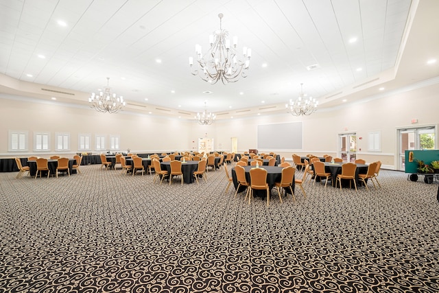 carpeted dining space featuring ornamental molding, a high ceiling, and a raised ceiling